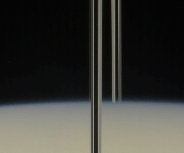 Mimas "rising" from behind Saturn